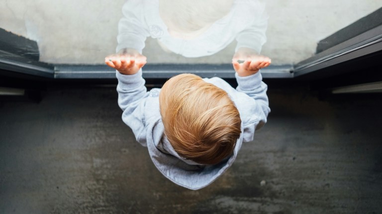 a child at the window of their home