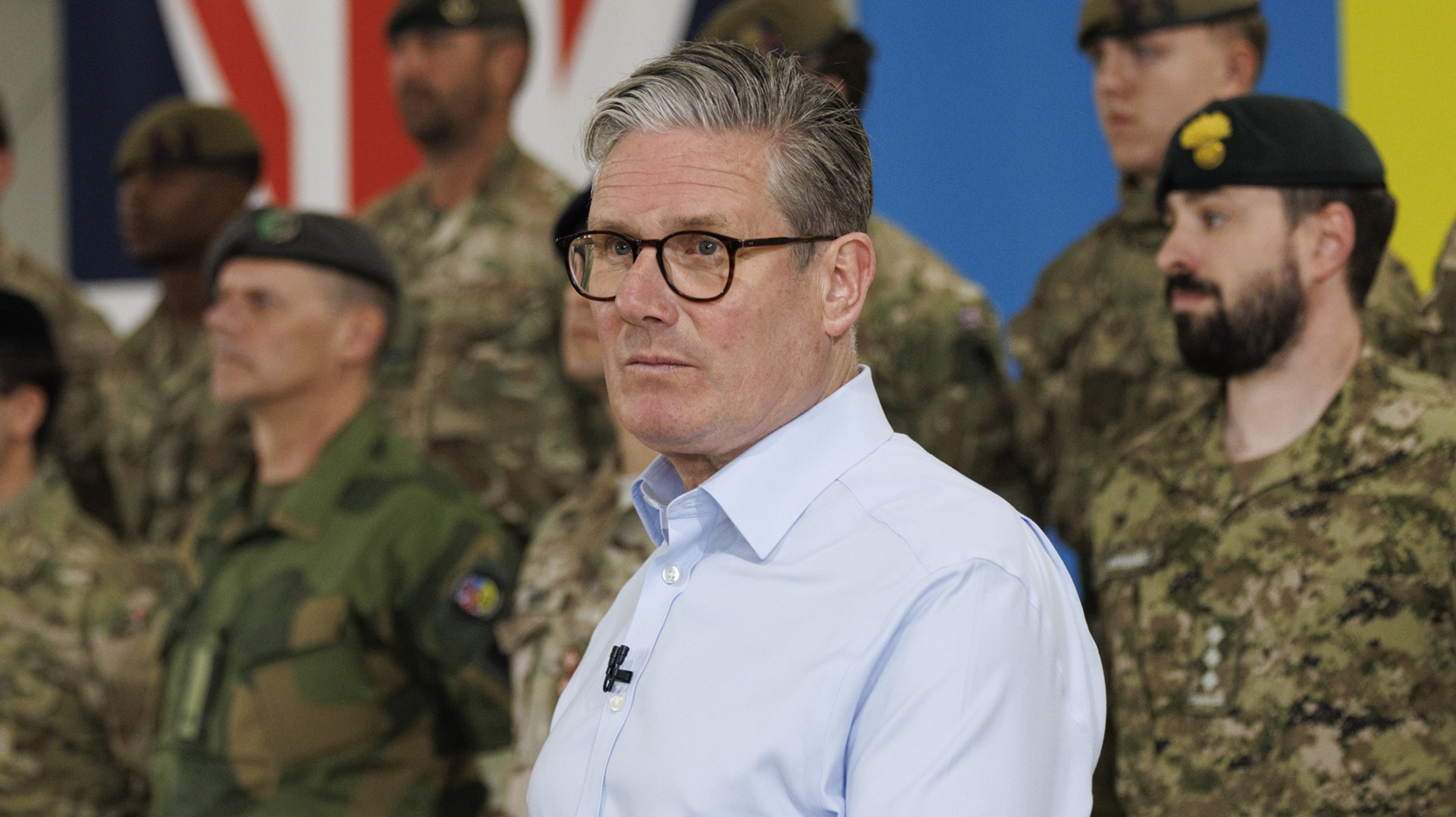 prime minister Keir Starmer standing in front of members of the armed forces