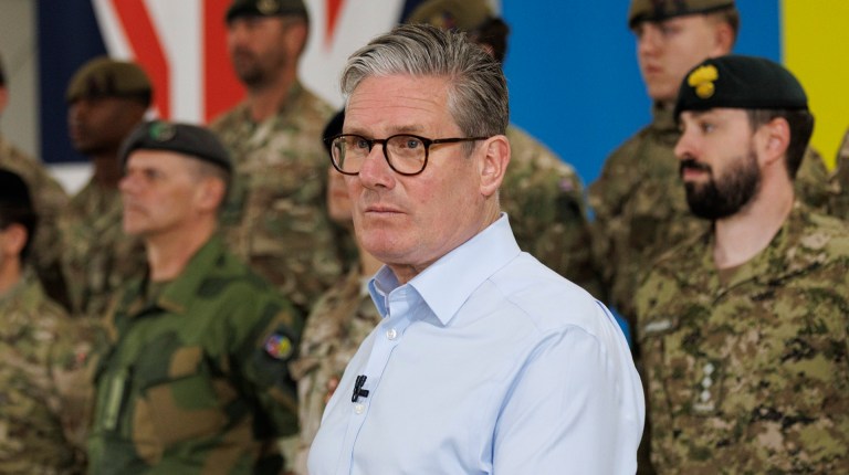 prime minister Keir Starmer standing in front of members of the armed forces