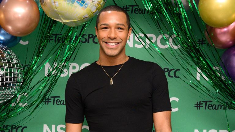 Former elite swimmer Michael Gunning poses against a green NSPCC background