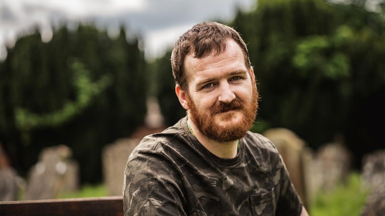 A bearded man sat on a bench