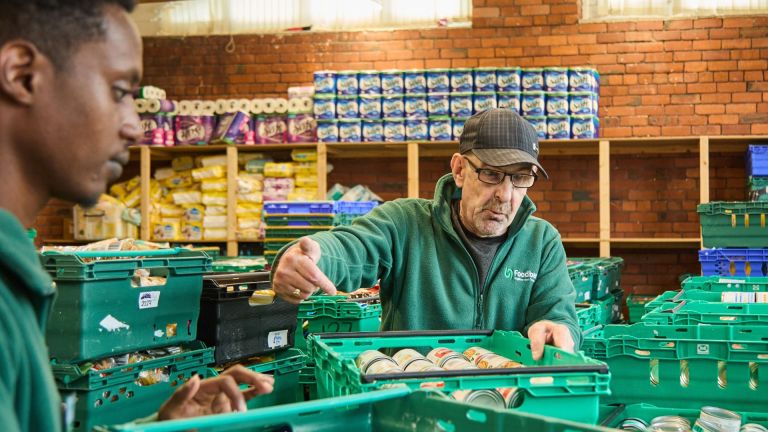 Image from food bank charity Trussell showing volunteers sorting through food donations