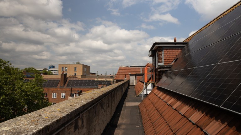 solar panels on the roof of a block of flats