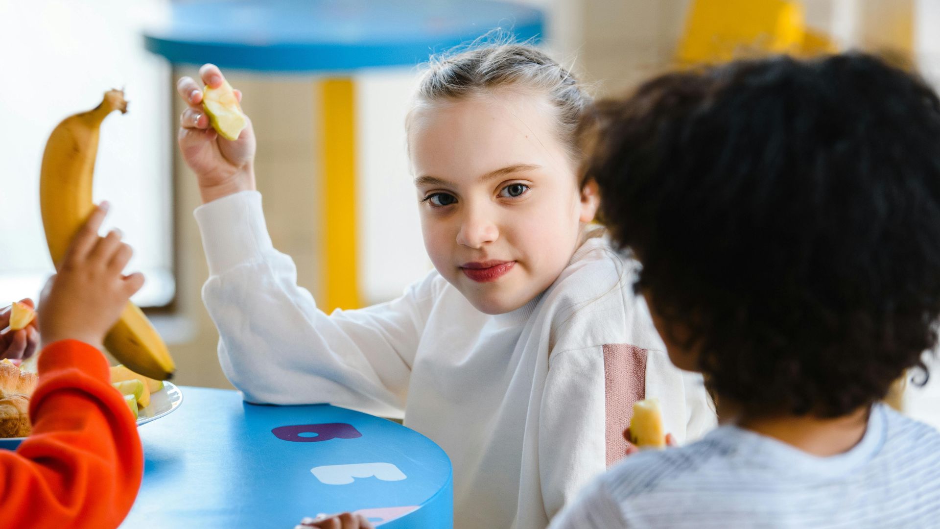 Stock image of children eating a school meal