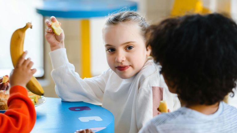 Stock image of children eating a school meal