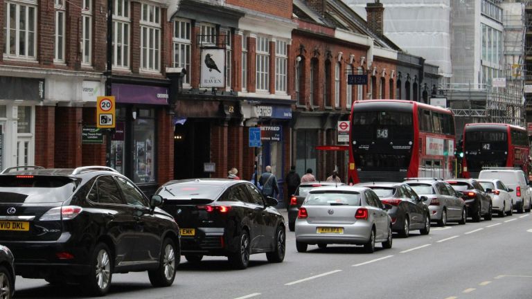 Stock image of a London street with cars and buses