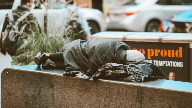 a person rough sleeping on a wall
