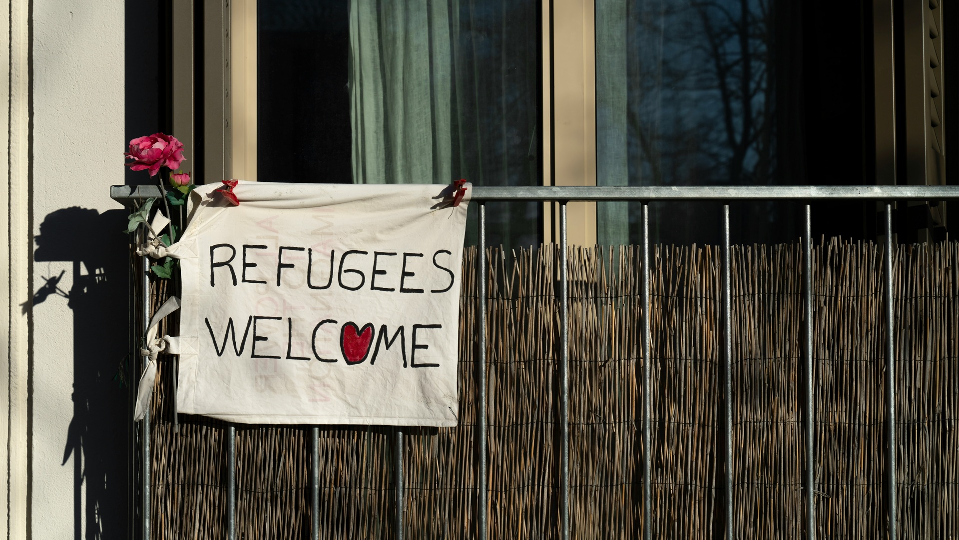 A Refugees Welcome sign on a fence