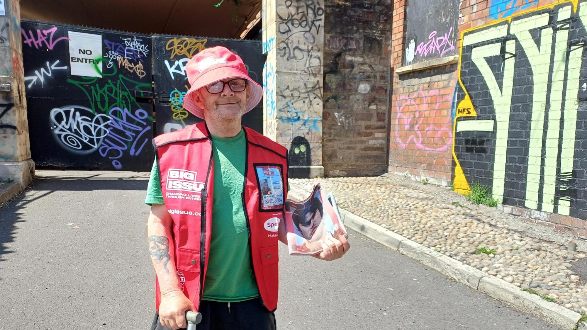 Vendor Bob Sheppard wears a Big Issue bucket hat from our summer support kit and holds our Oasis issue outside Big Issue's Bristol offices.