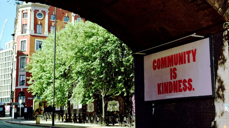 A billboard reading Community is Kindness
