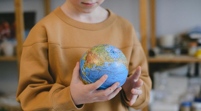 A child holding a globe