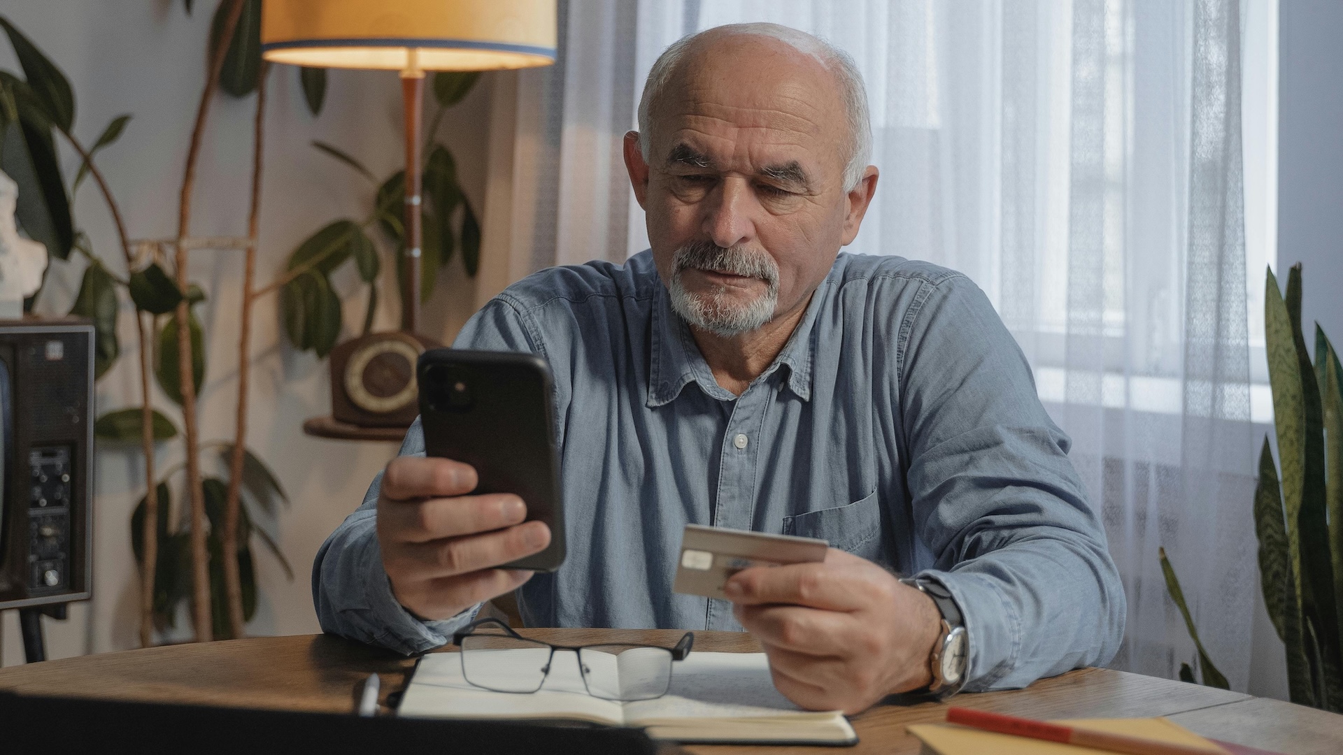 Image of an older man paying money