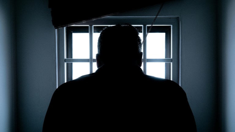 a prisoner behind prison bars