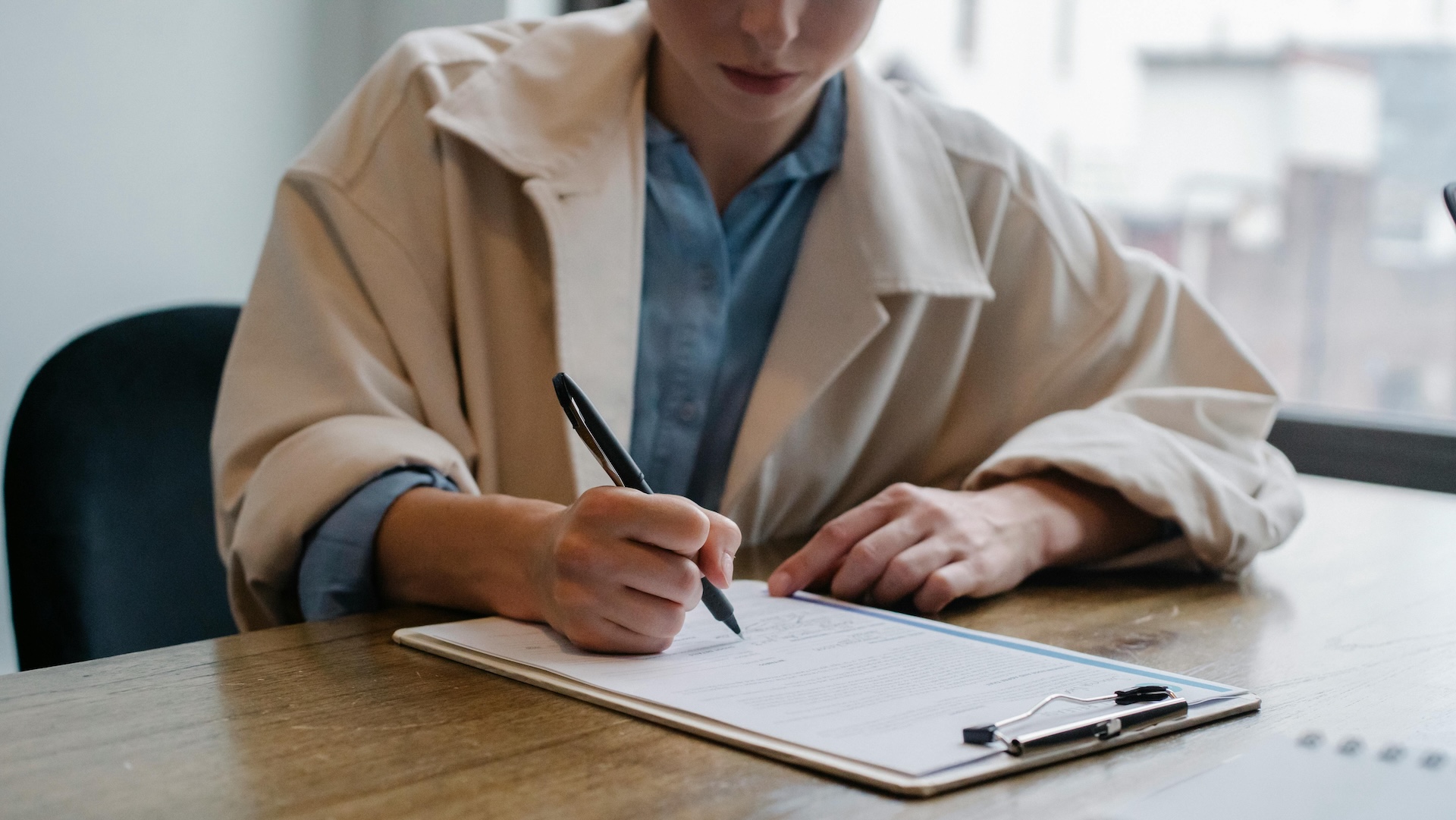 A person filling out a form