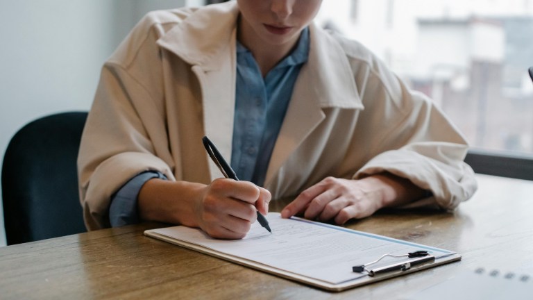 A person filling out a form