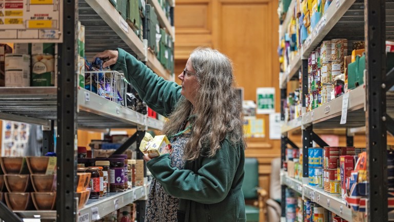 A Trussell food bank worker sorting food parcels. Image: Dan Prince