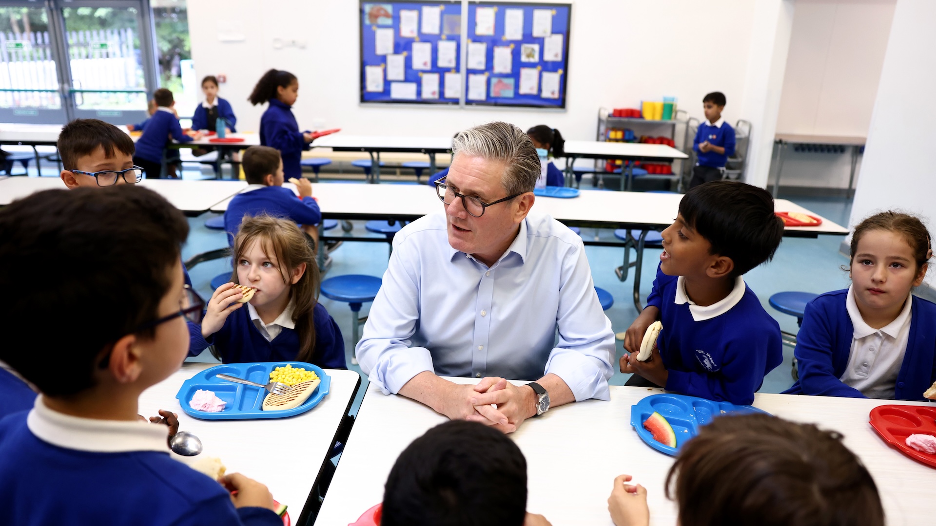 Keir Starmer alongside school children on the day he announced the expansion of free school meals.