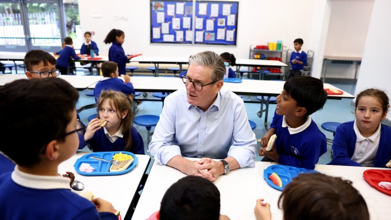 Keir Starmer alongside school children on the day he announced the expansion of free school meals.