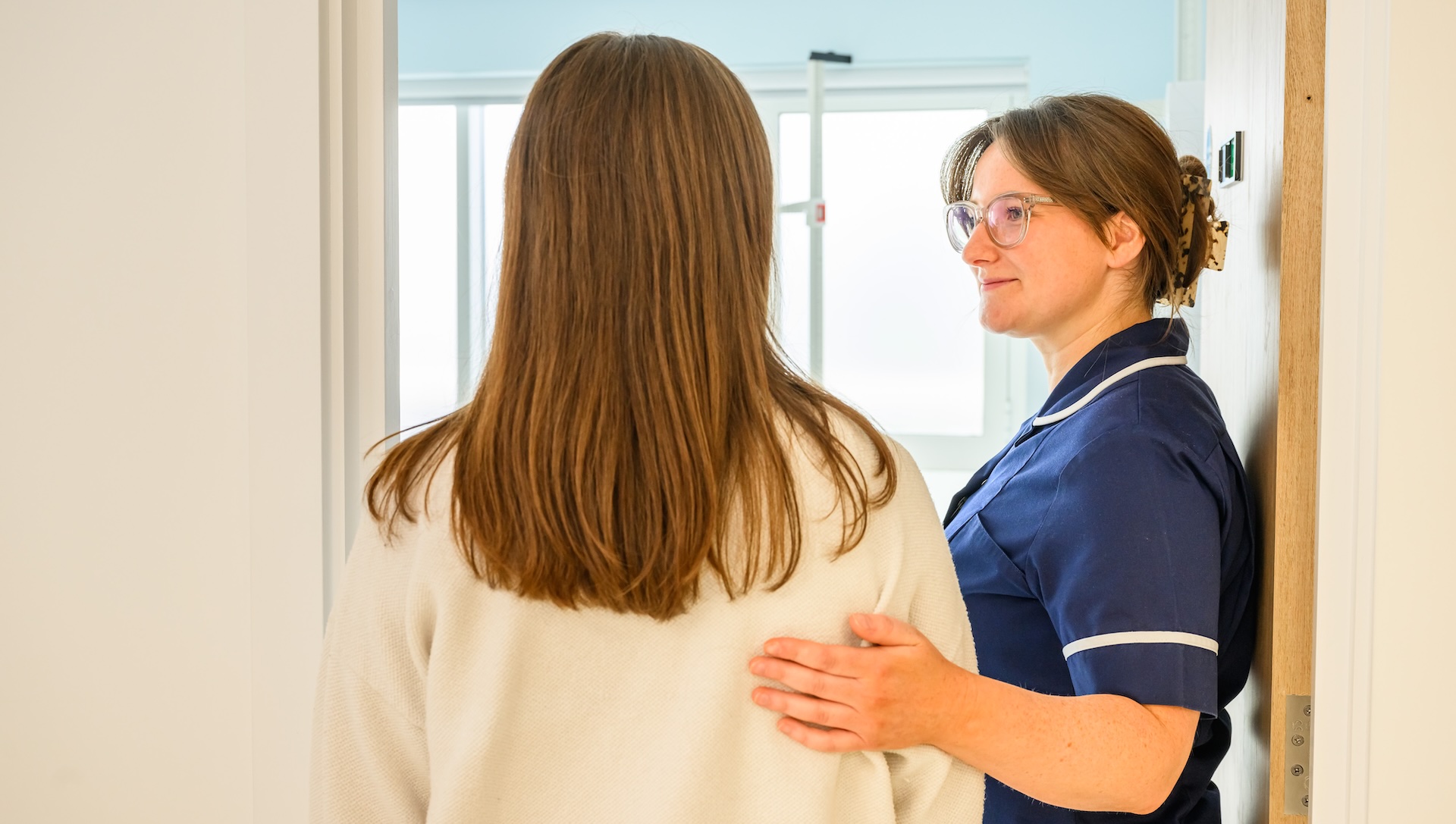 a woman being supported by a nurse