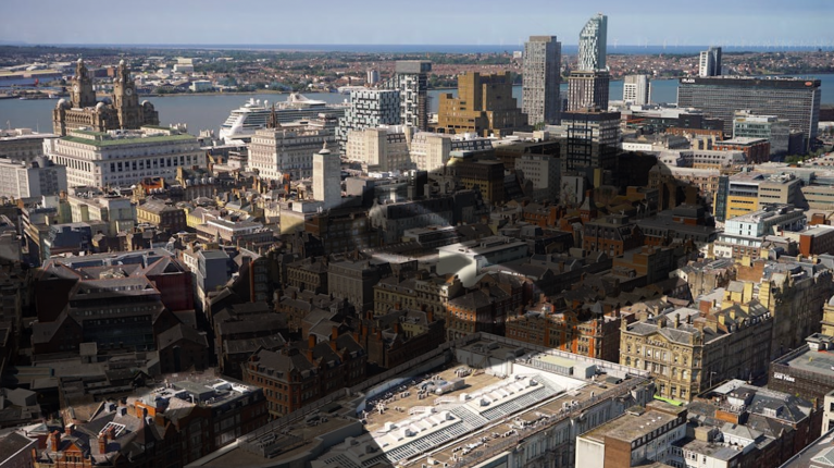 A shadow of Keir Starmer superimposed over an aerial shot of Liverpool