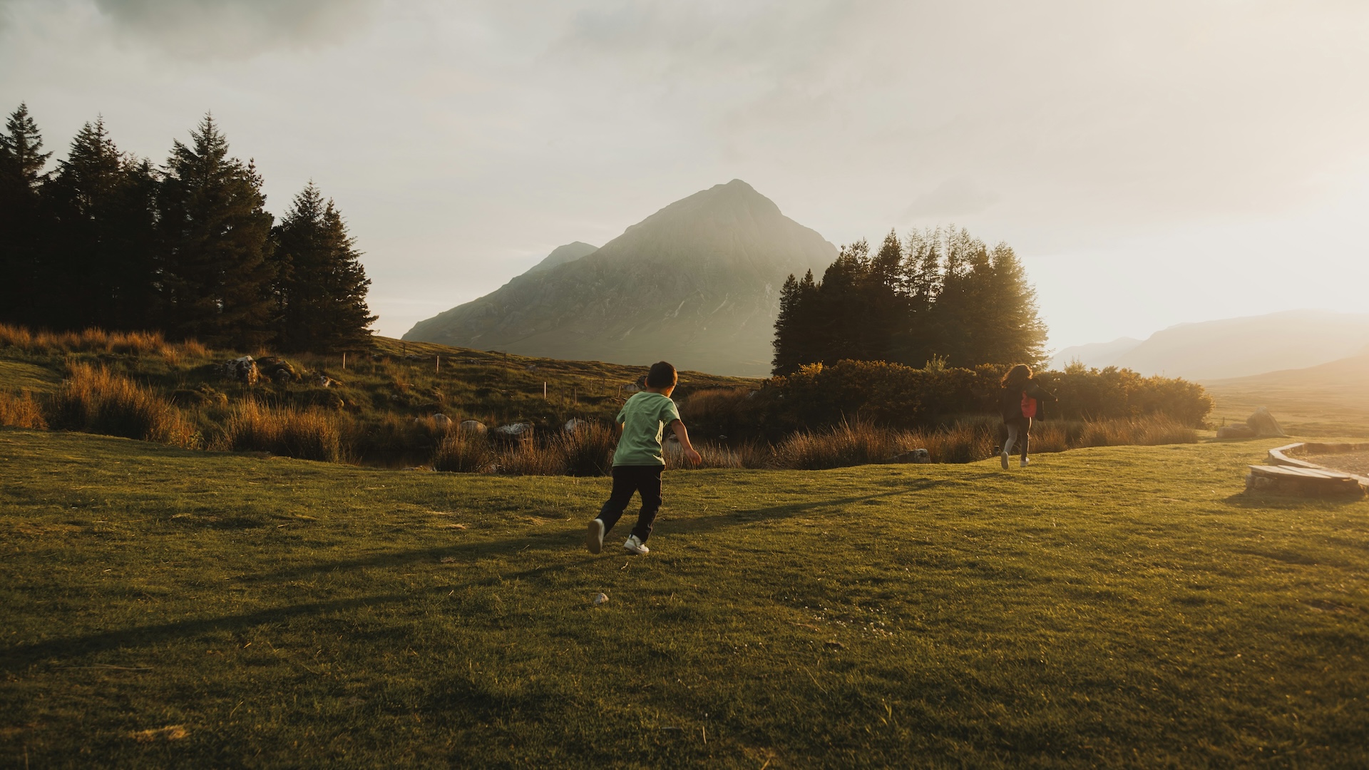 Children running through the Scottish highlands.