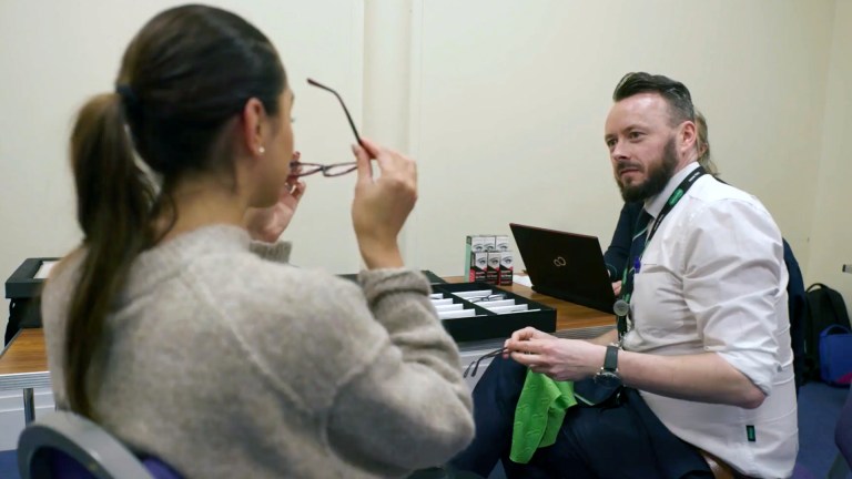 Specsavers optometrist conducting eye test with client in community setting as part of Home Visits program for people experiencing homelessness