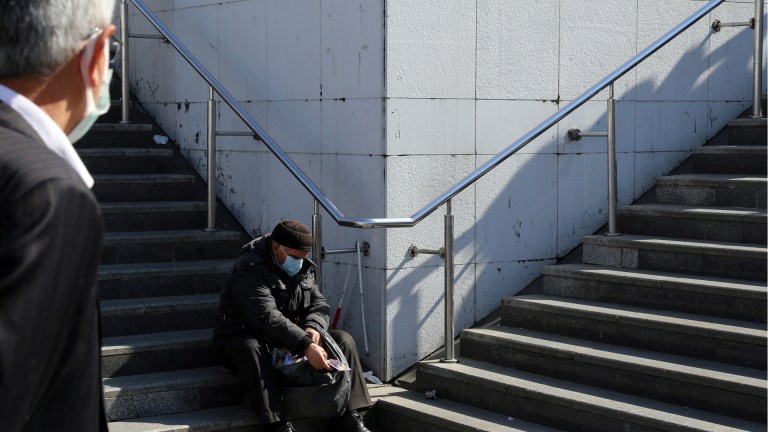 a person experiencing homelessness on the street