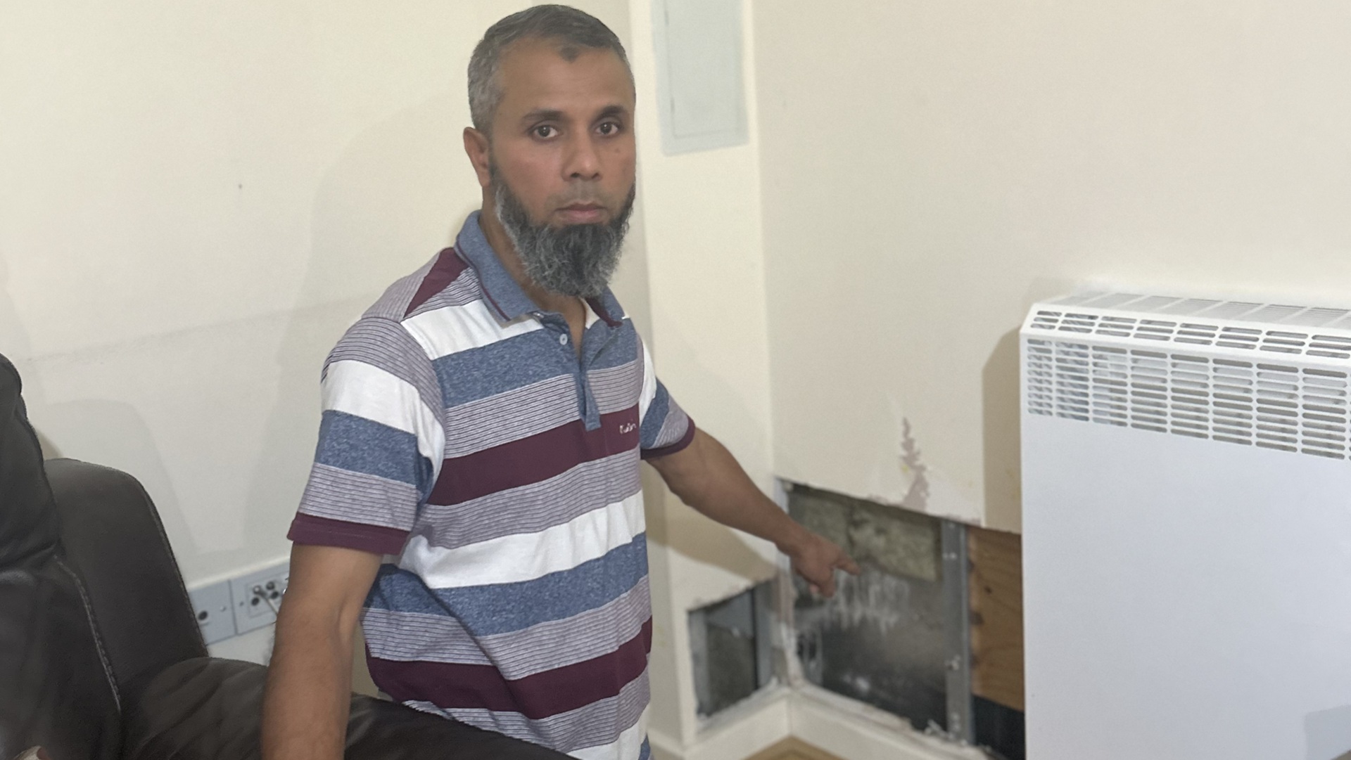 Londoner Syed Alam shows the hole in his living room