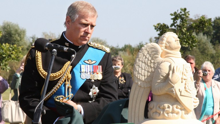 Disgraced royal Prince Andrew looking at a statue
