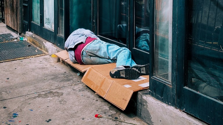 a man sleeping rough on the street