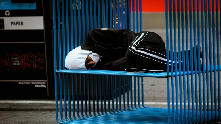 a homeless man sleeping rough