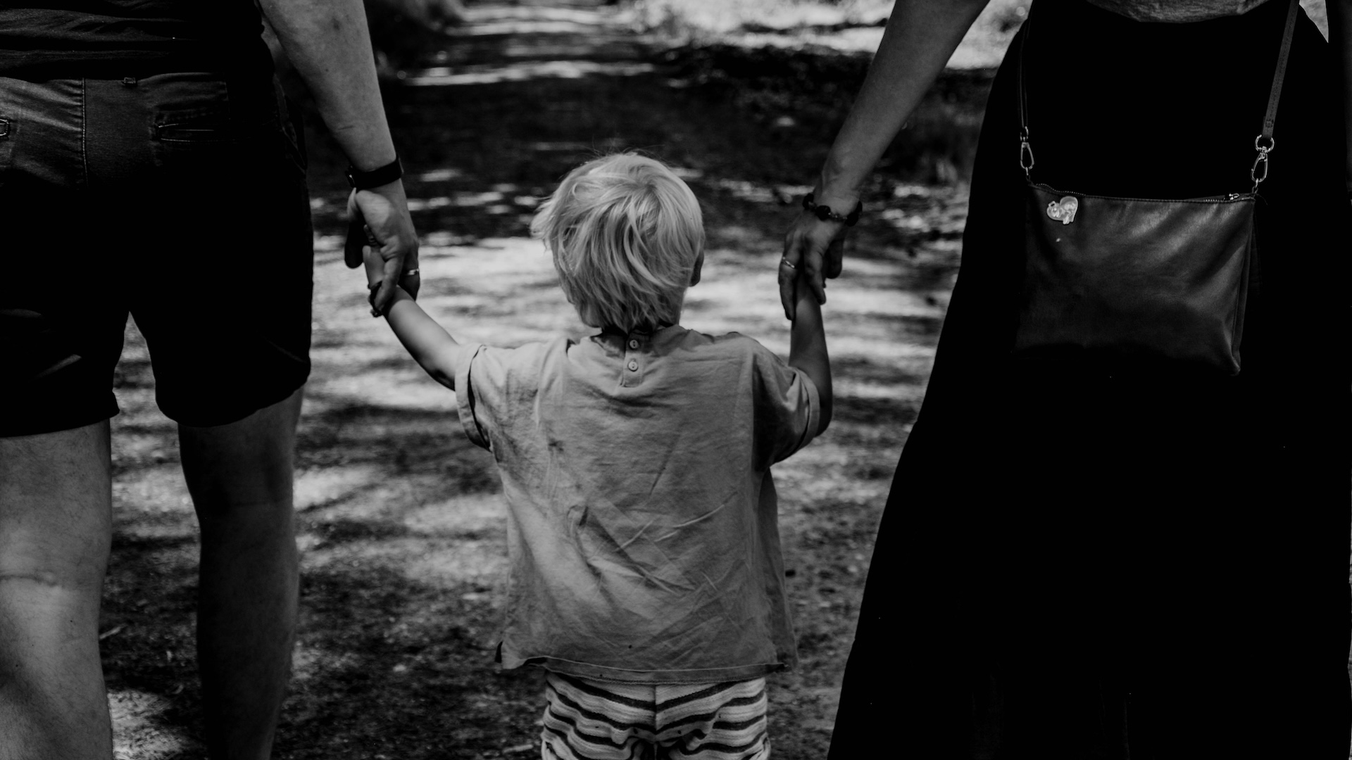 Parents holding a child's hand