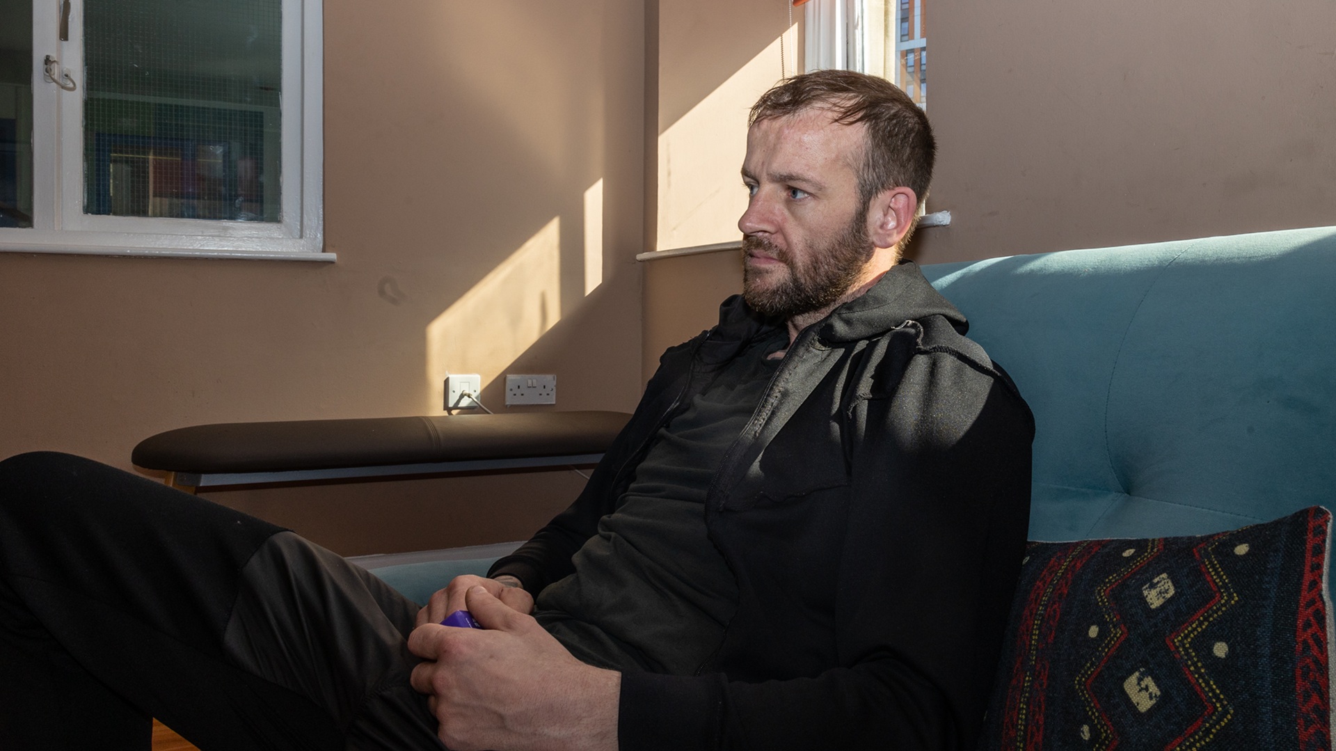 a homeless man pictured in his temporary accommodation