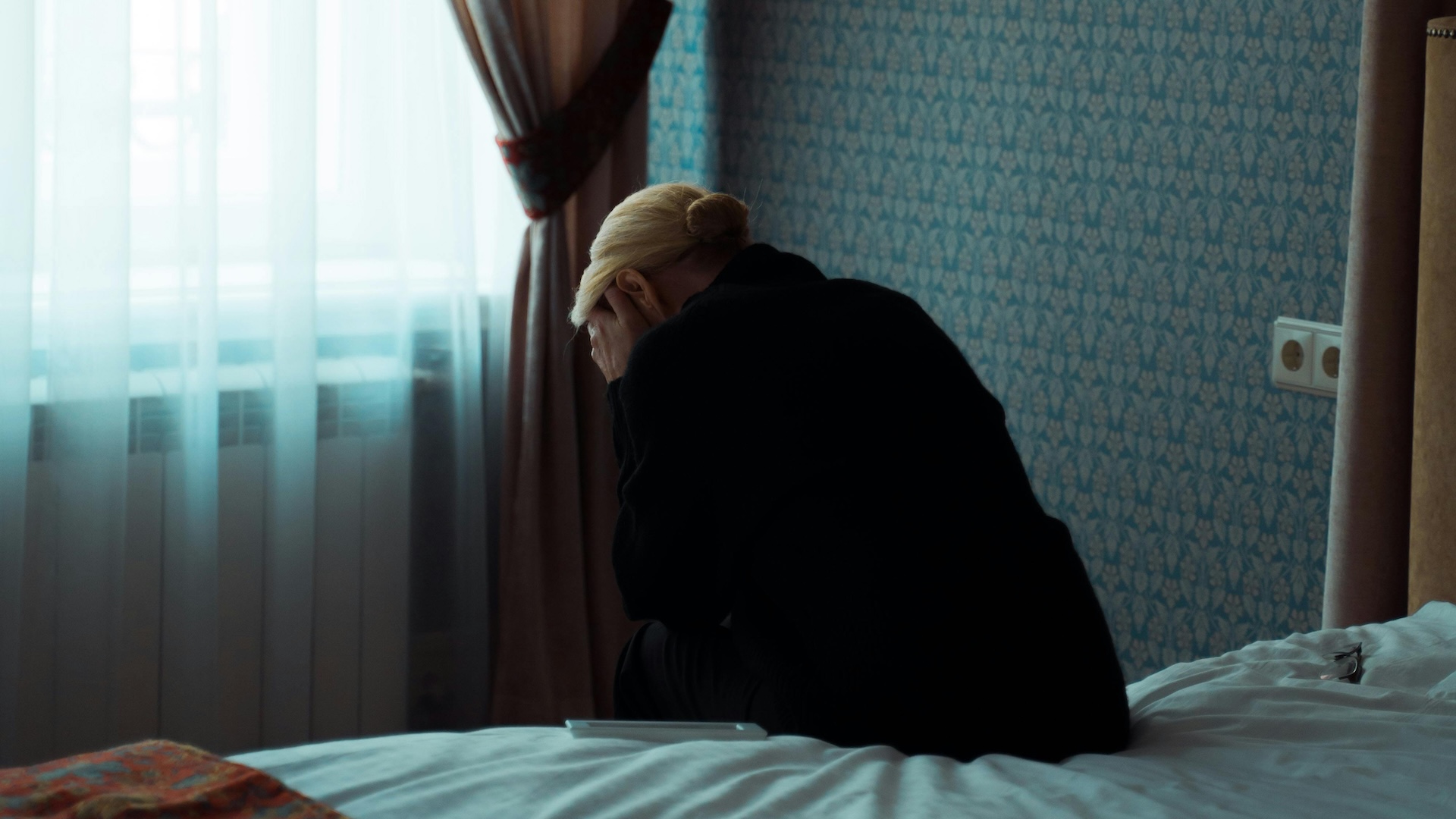 A woman holding her face in her hands