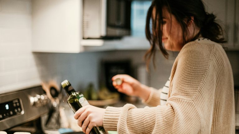 a woman pouring olive oil
