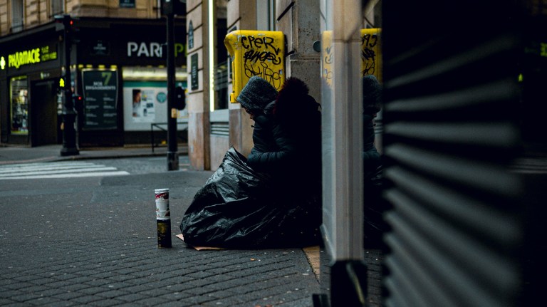 a homeless person sleeping rough on the streets