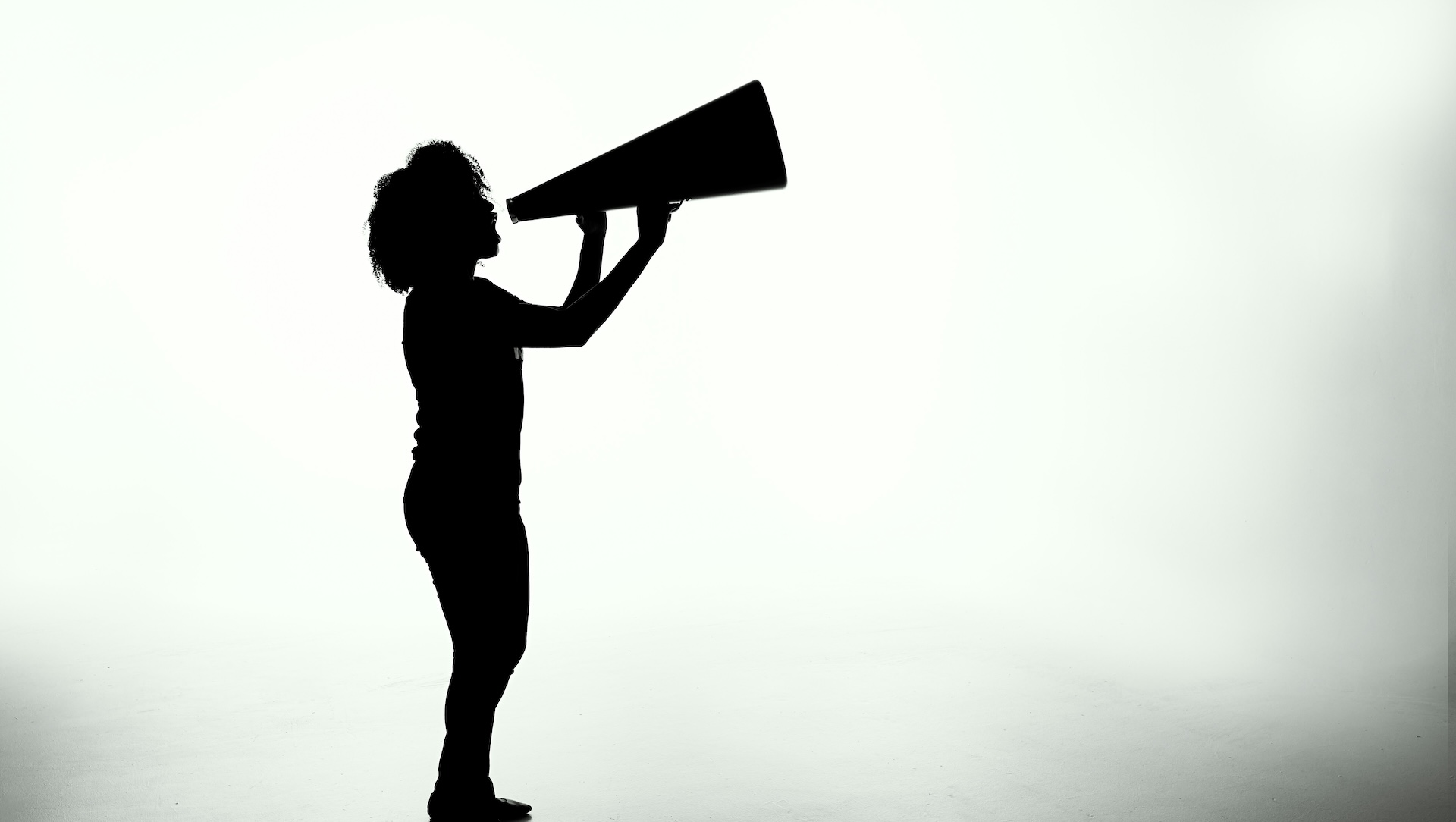 silhouette of woman speaking out