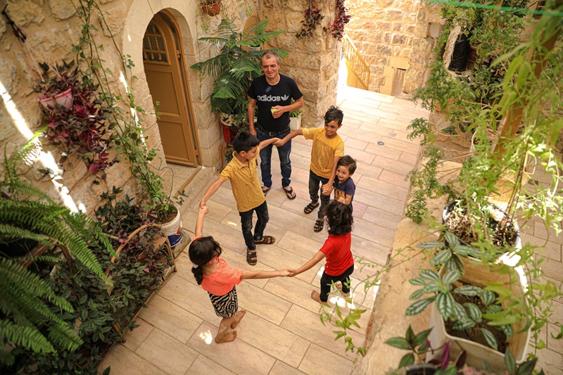 Kids playing in the rehabilitated open area of their home in Hebron