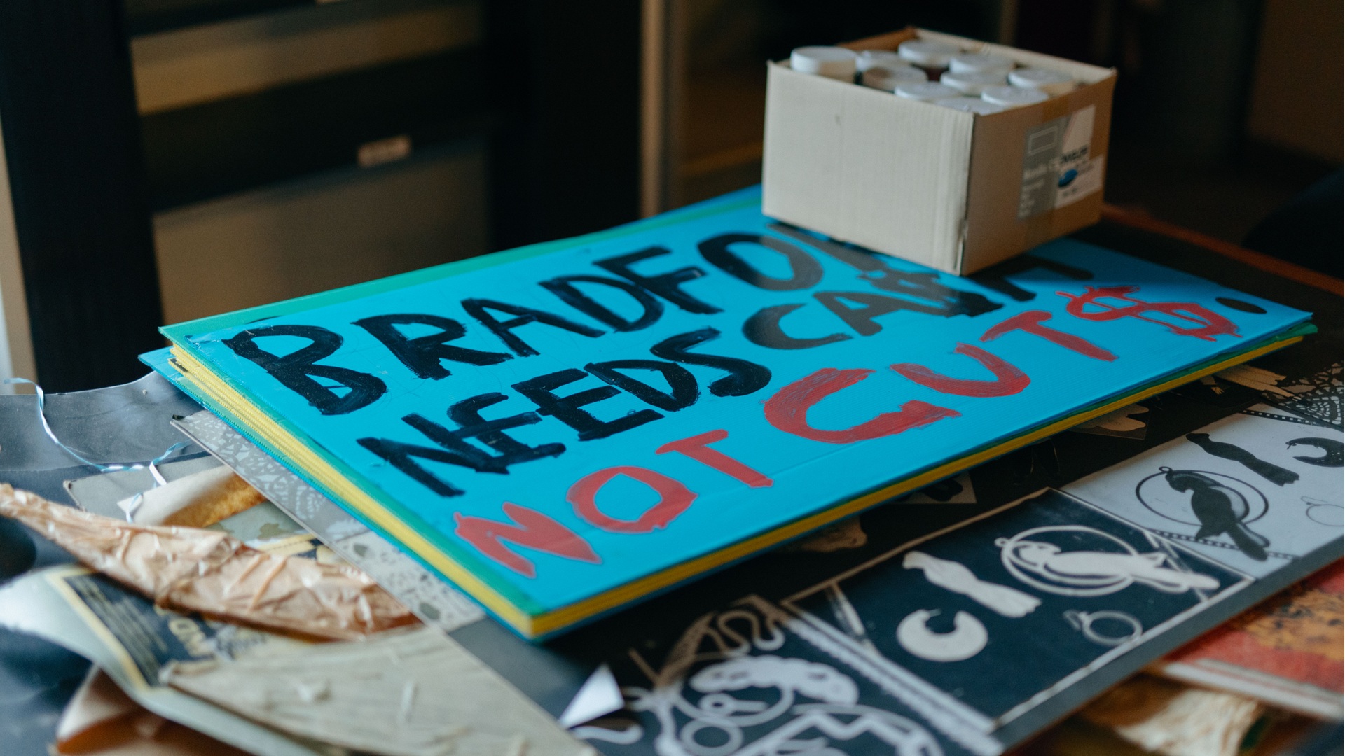 A placard reading Bradford needs cash not cuts