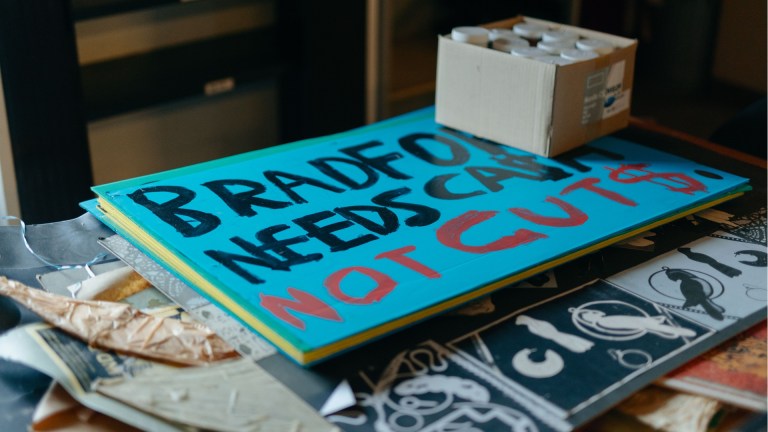 A placard reading Bradford needs cash not cuts