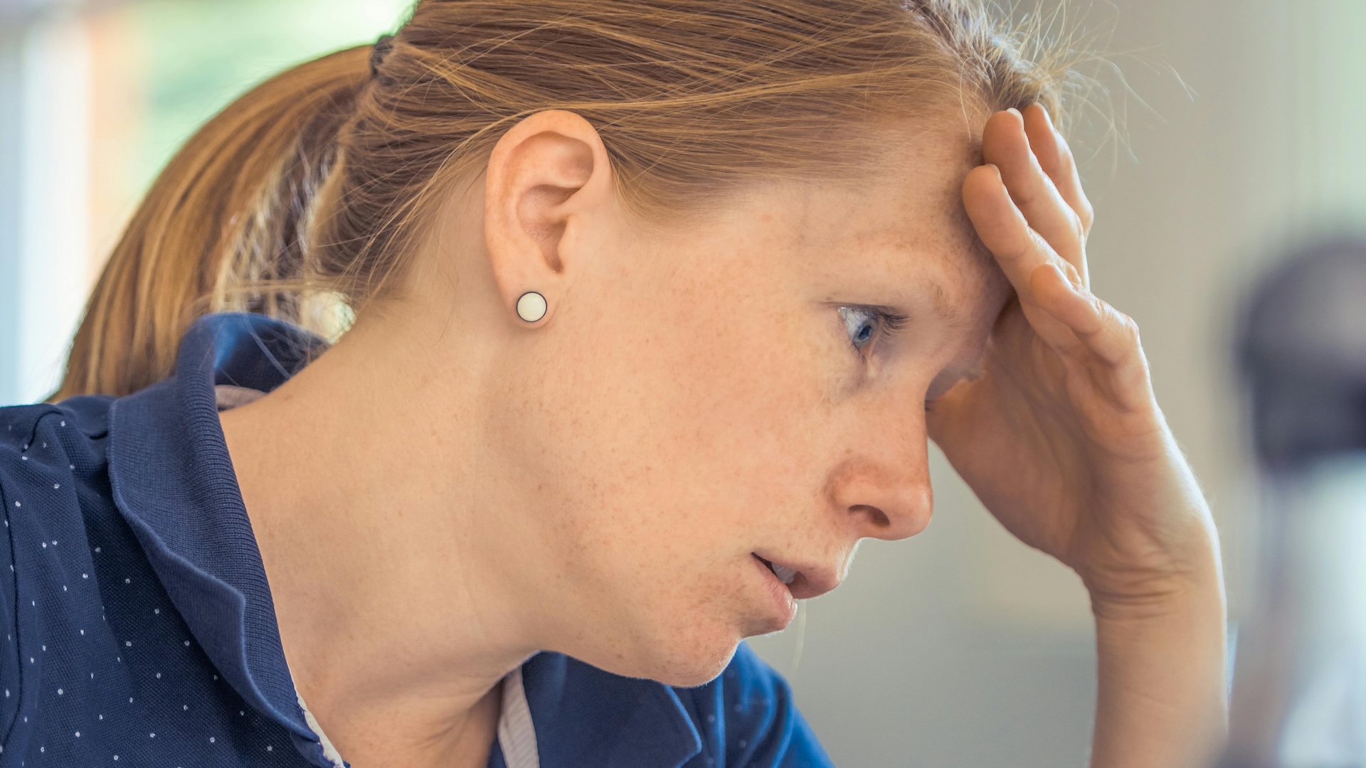 Woman with head in hands
