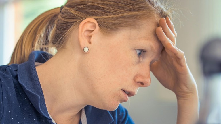 Woman with head in hands