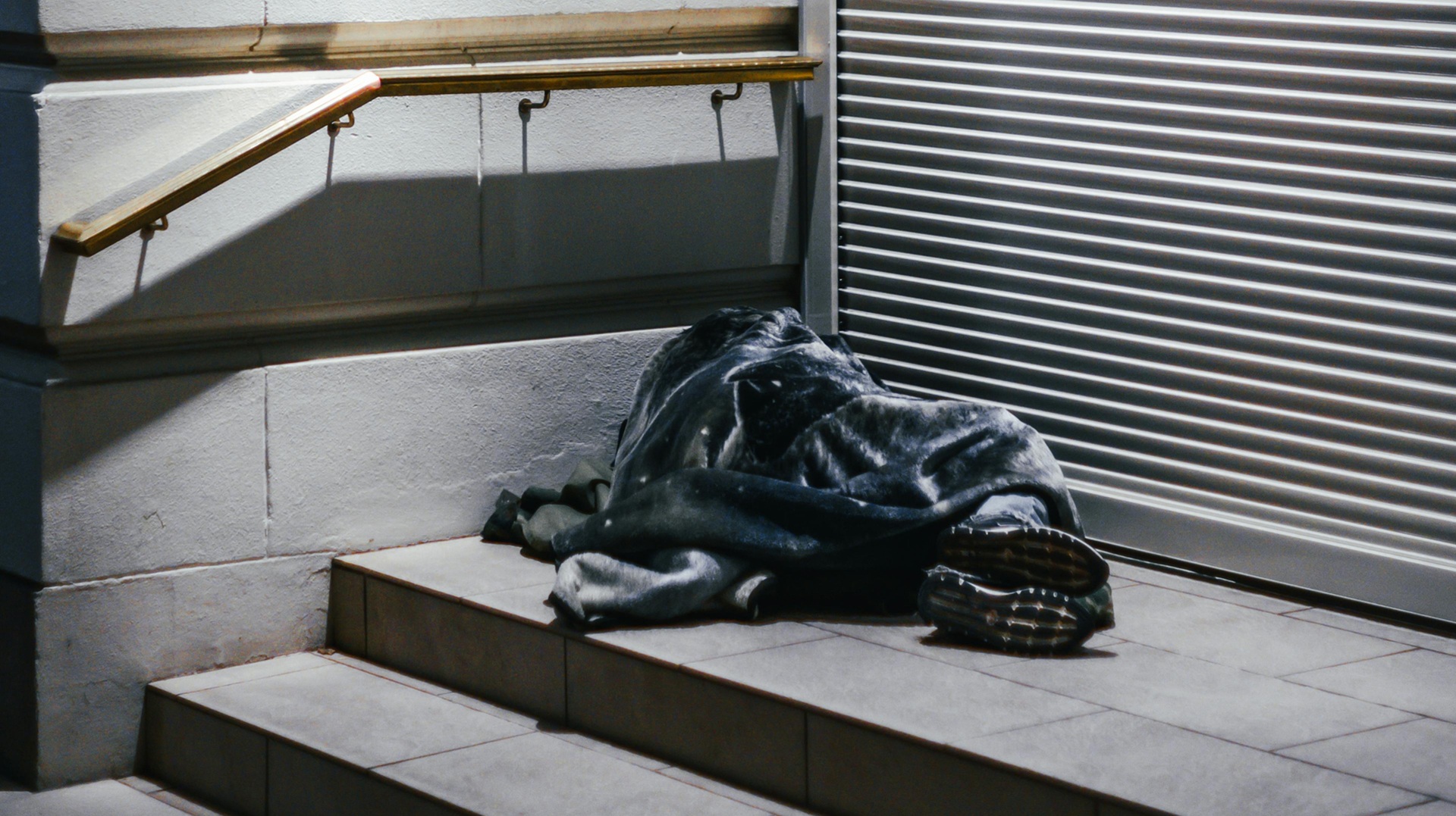 a person sleeping rough in a doorway