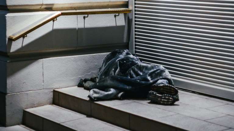 a person sleeping rough in a doorway