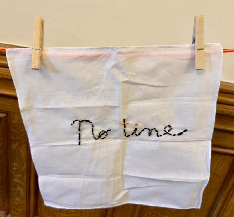 A stitching reading 'No Time'