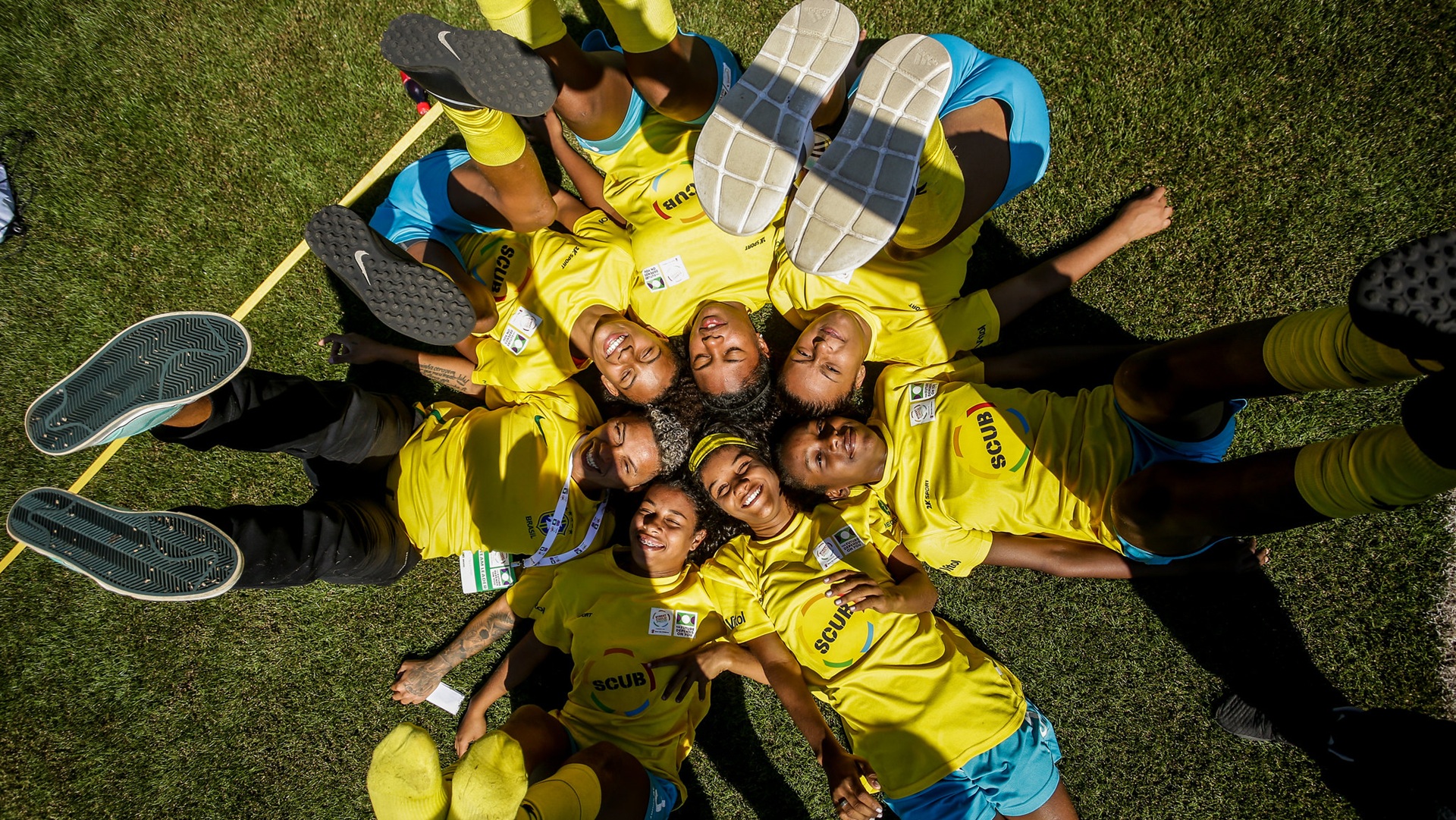 a number of players from the Street Child World Cup lying down with their feet in the air