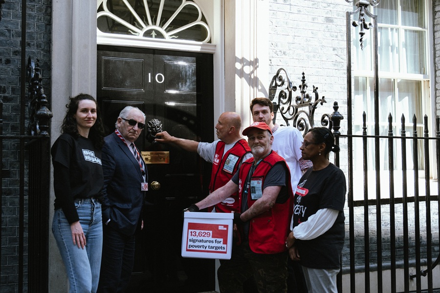 Big Issue vendors and staff hand in a petition about poverty targets at parliament