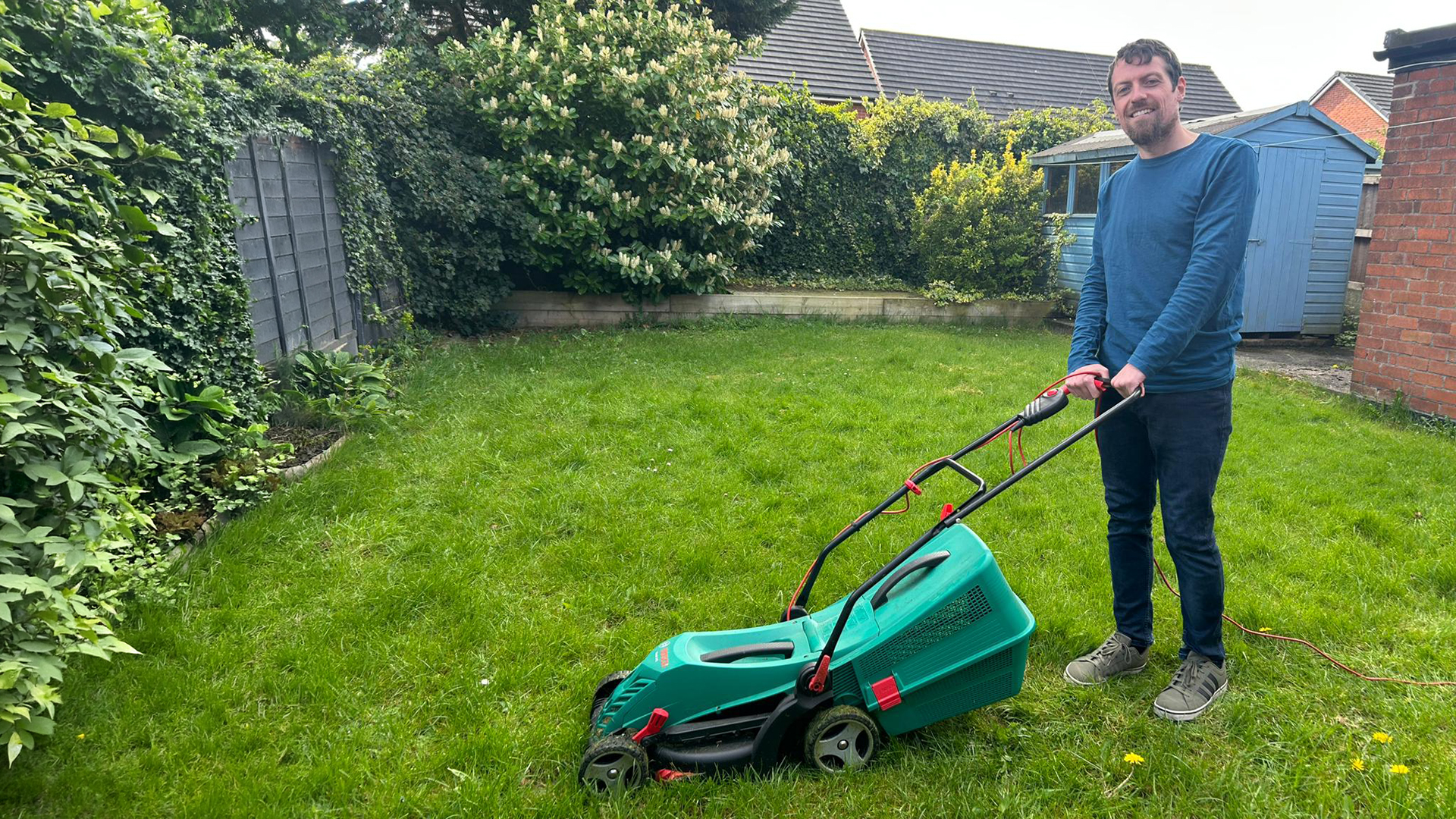Big Issue deputy editor Liam Geraghty with his lawn mower.