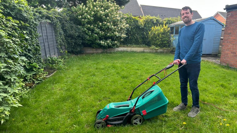 Big Issue deputy editor Liam Geraghty with his lawn mower.