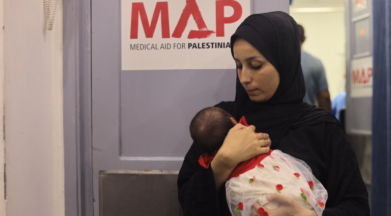 A young mother with her baby in Gaza City